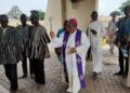 Bishop Peter Paul Blesses Jakpa Palace with holy water.